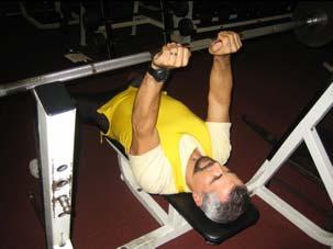 Primarily using the muscles at the back of the upper arms (triceps), lower the body until the elbows are at 90 degrees.