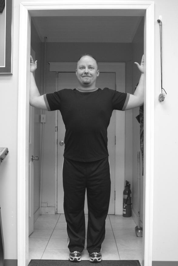The Wellness Practice Doorway Stretch Stand in doorway with shoulders and elbows at right angles keep head pulled back and chin slightly tucked.