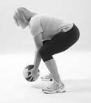 Allowing your hips to go back, bend your knees and squat down until your thighs are parallel to the ground.
