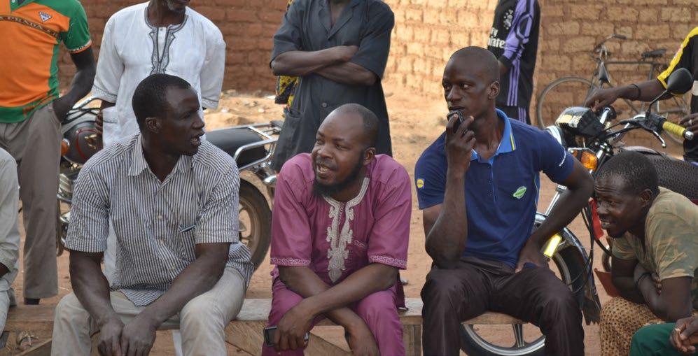Men gather to listen to a community health discussion about the benefits of family planning. The availability of family planning options allows women and couples to achieve their desired family size.