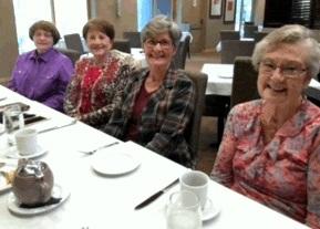 (Picture 2) Members Pam Everett, Nancy Danby, and Mimi Lewellen are enjoying the beautiful wall decoration in addition to the wonderful food.