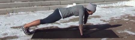 As you lower yourself to a push-up, bring your left knee to meet your left elbow ().