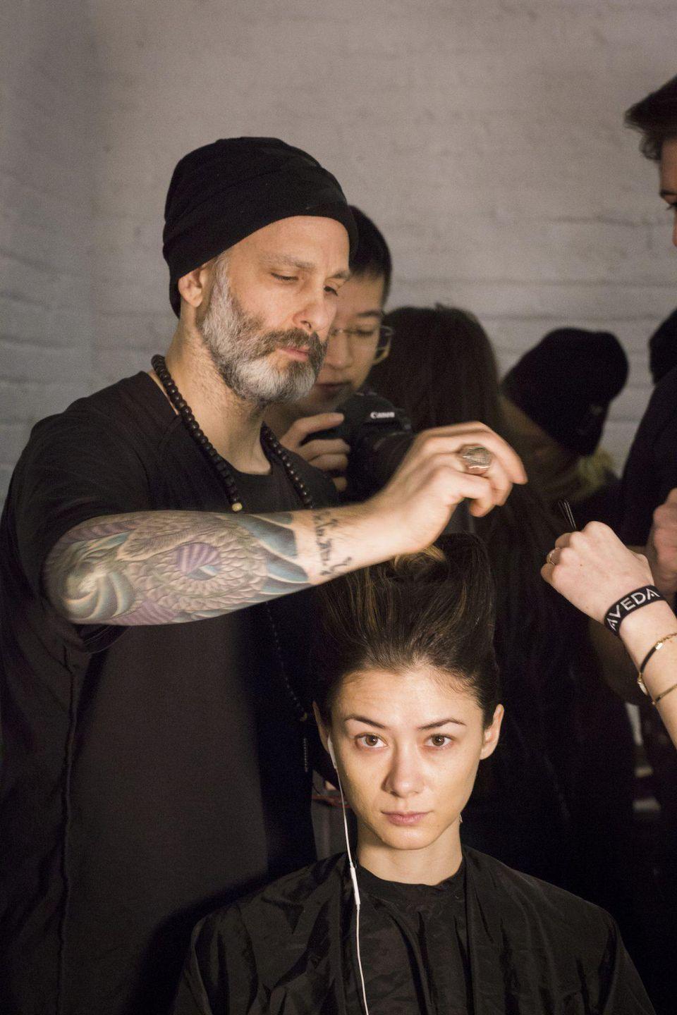 Jon Reyman styling models backstage PHOTO CREDIT: CAROLINE CUSE https://www.forbes.