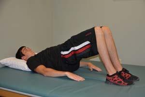 Exercise 4: Pelvic Lift Starting Position: Lie on your back on a table or flat surface. Your feet are flat on the surface and your knees are bent. Keep your legs together.