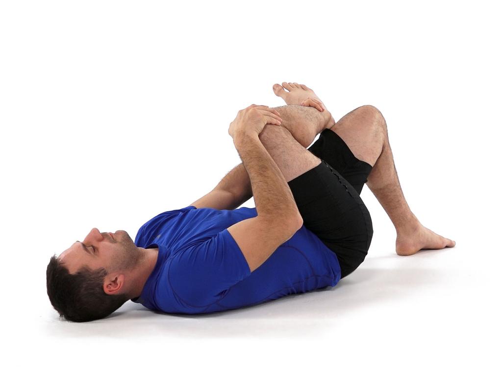 5- Stretching piriformis - / Lie on your back and have one leg bent. Place the ankle of the opposite leg over the knee in a figure 4 position.