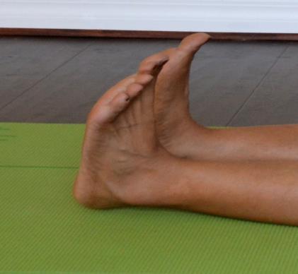 Interlace Fingers between Toes: Interlace fingers between your toes to flex, point toes and rotate ankle in both clockwise and counterclockwise directions